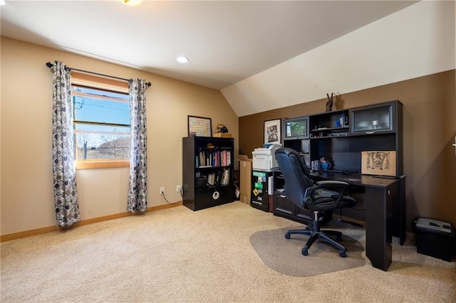 carpeted home office featuring lofted ceiling