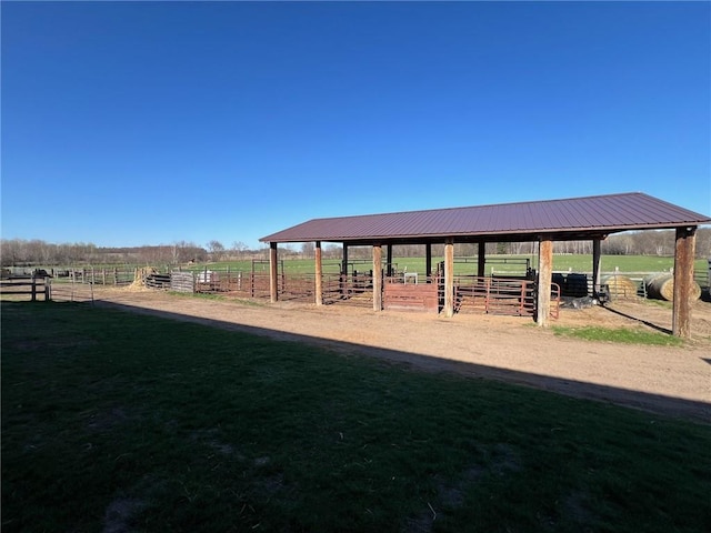 surrounding community with a rural view and an outdoor structure