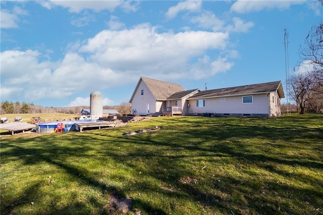 rear view of property with a lawn