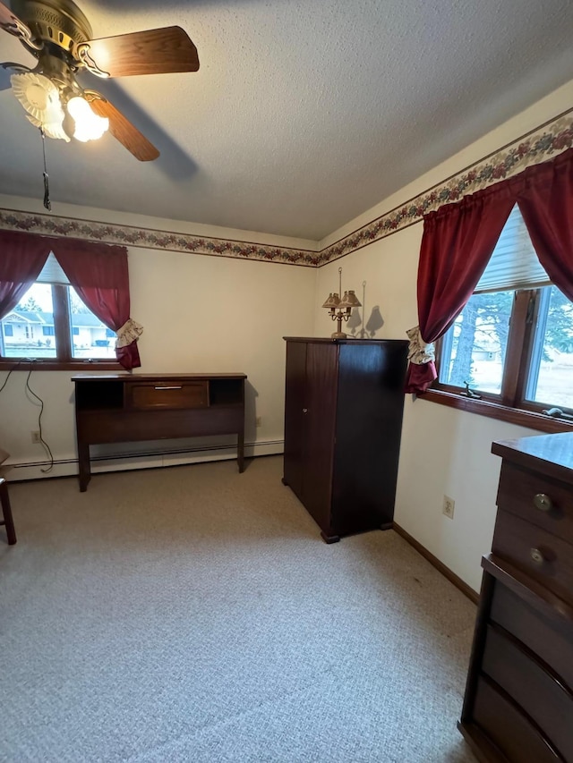 bedroom with ceiling fan, a baseboard heating unit, light colored carpet, and multiple windows