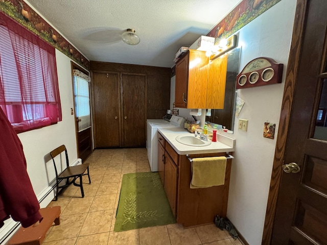 bathroom with baseboard heating, tile patterned floors, a textured ceiling, washer and clothes dryer, and vanity