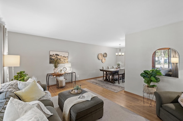 living room with wood-type flooring and a notable chandelier