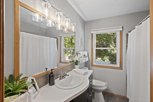 bathroom with toilet, a shower with curtain, vanity, and tile patterned floors