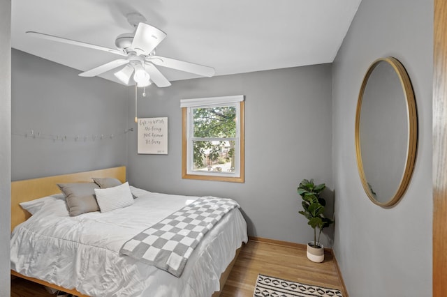 bedroom with ceiling fan and hardwood / wood-style floors