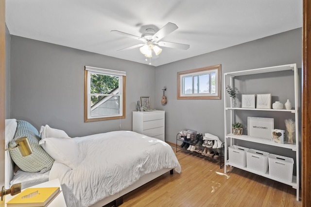 bedroom with ceiling fan and wood-type flooring