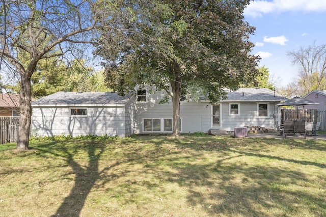 rear view of property with a yard and a patio area