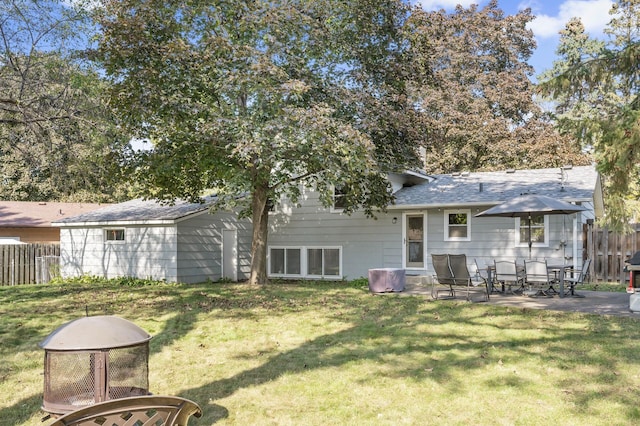 rear view of property featuring a yard and a patio