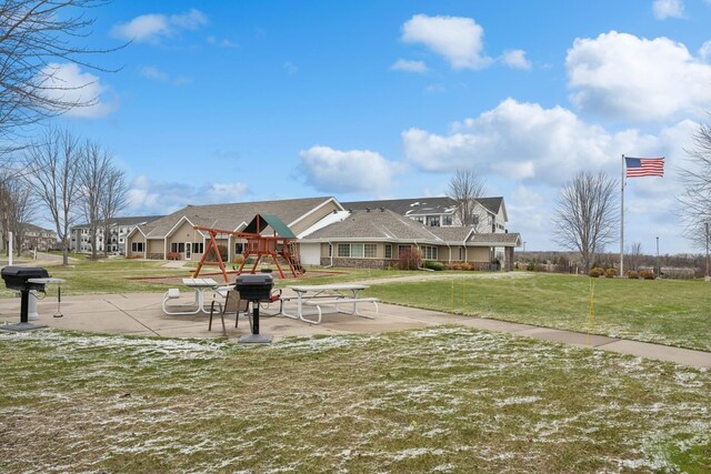 view of community with a playground and a yard