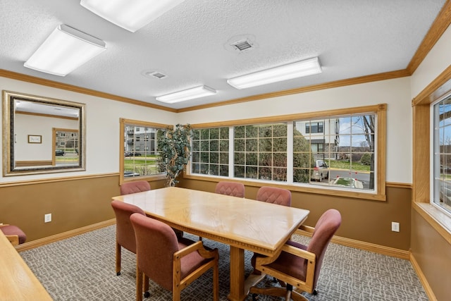 dining space featuring hardwood / wood-style flooring, plenty of natural light, ornamental molding, and a textured ceiling