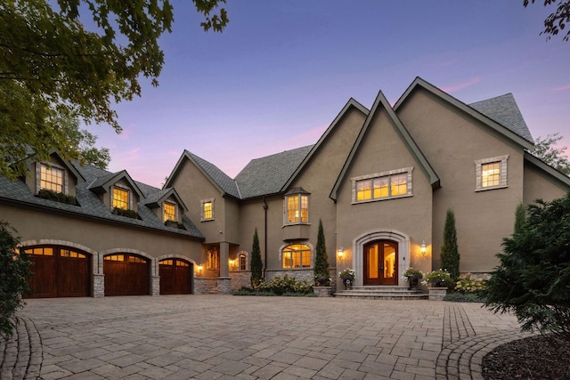 french country home featuring french doors and a garage