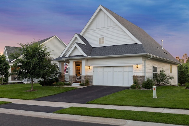 craftsman inspired home featuring a garage and a lawn