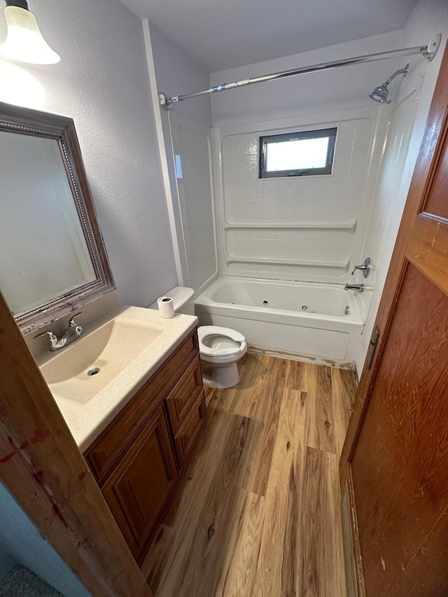 full bathroom featuring bathtub / shower combination, wood-type flooring, vanity, and toilet