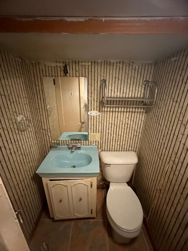 bathroom with tile patterned flooring, vanity, and toilet