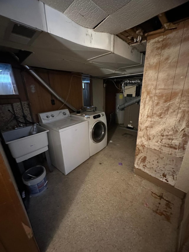 laundry room featuring washer and dryer, water heater, and sink