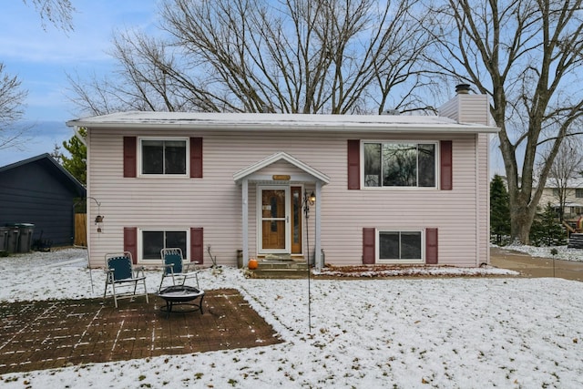 bi-level home with a fire pit