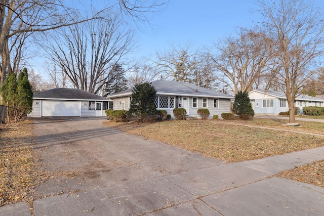 ranch-style home featuring a garage and a front yard