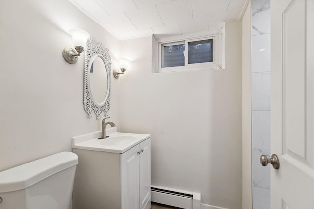 bathroom featuring vanity, toilet, ornamental molding, and a baseboard heating unit