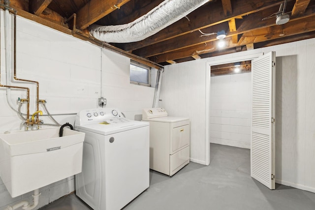 washroom featuring washing machine and dryer and sink