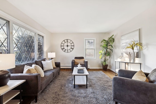 living room with baseboard heating and dark hardwood / wood-style floors