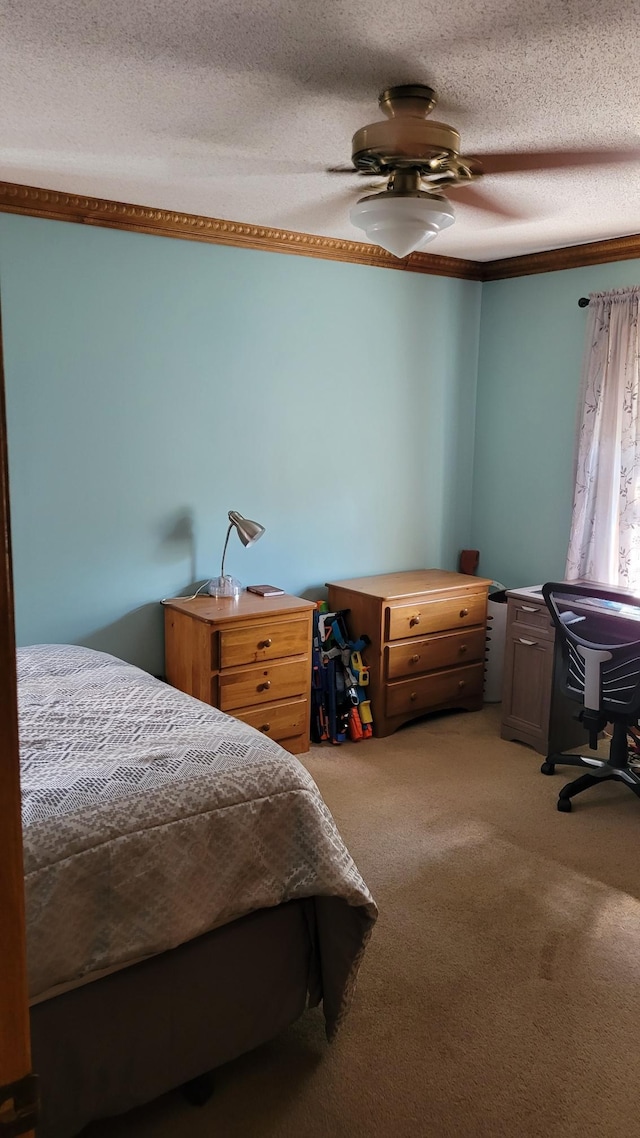 carpeted bedroom featuring ceiling fan and a textured ceiling