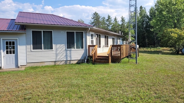 back of house with a lawn and a wooden deck