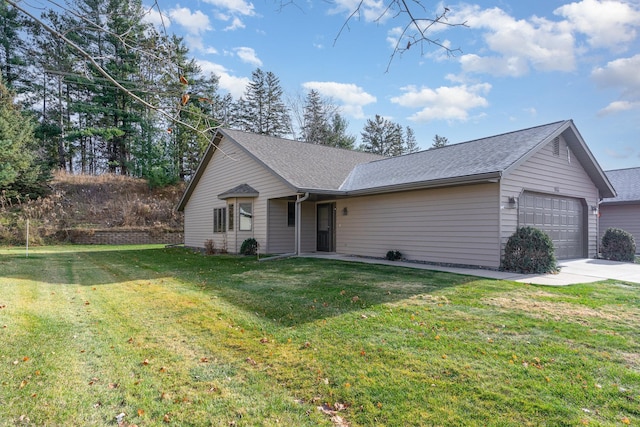 ranch-style house with a garage and a front lawn