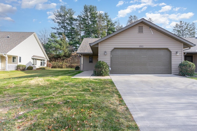 view of front of house featuring a front yard and a garage