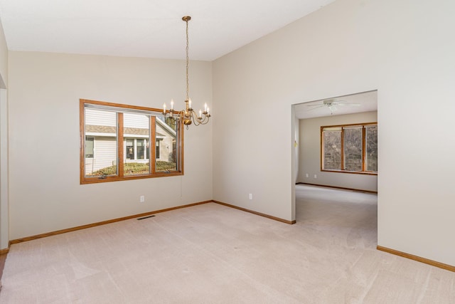 empty room with light carpet, ceiling fan with notable chandelier, and lofted ceiling