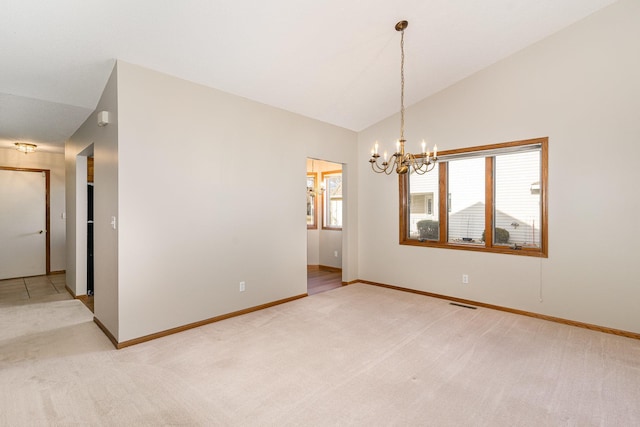 carpeted spare room with a notable chandelier and vaulted ceiling