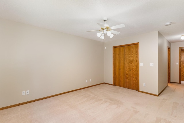 carpeted empty room with ceiling fan and a textured ceiling