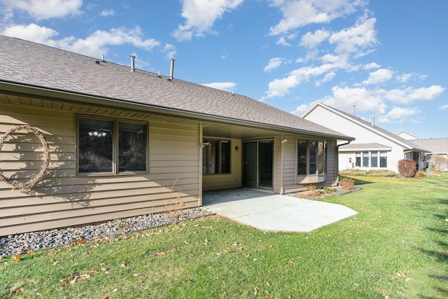 back of house with a patio and a lawn