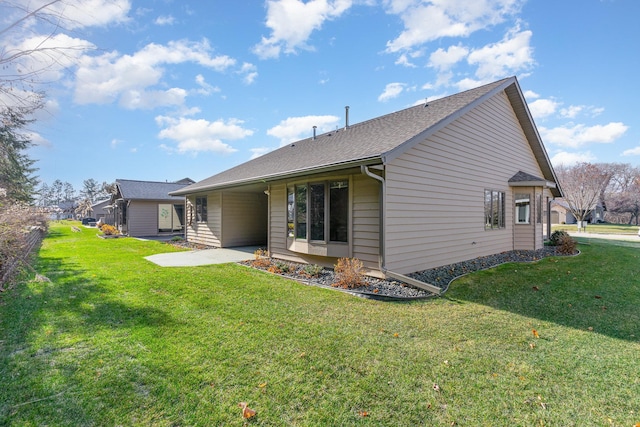 rear view of property with a lawn