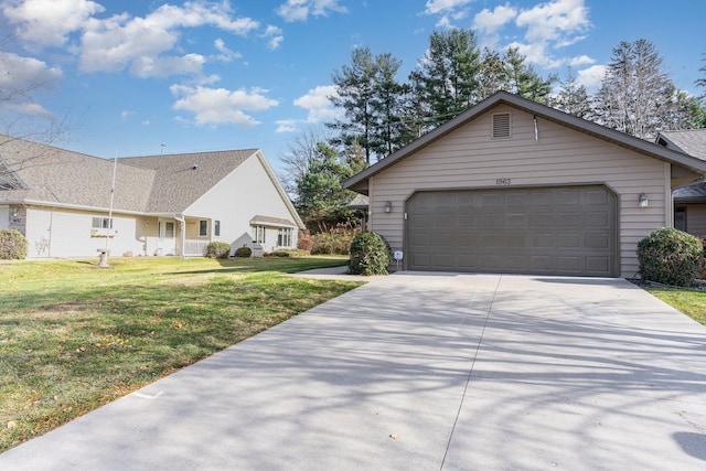 view of front of home featuring a front lawn and a garage