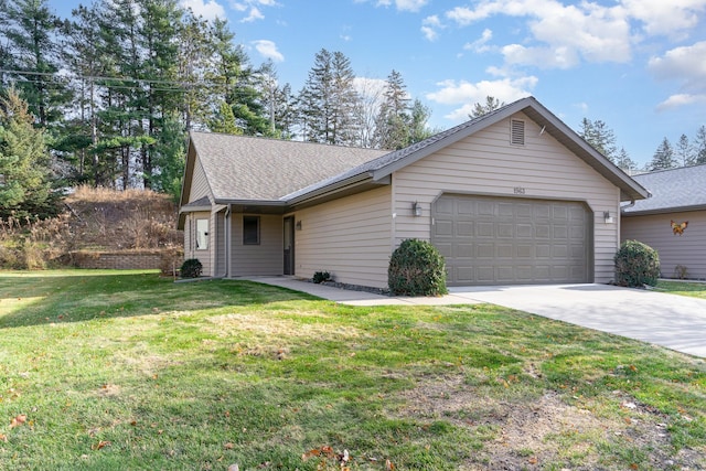 ranch-style house featuring a front yard and a garage