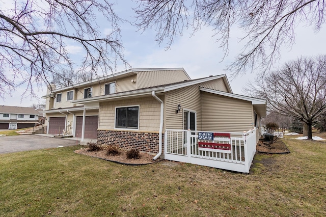 view of front of home with a front lawn and a garage