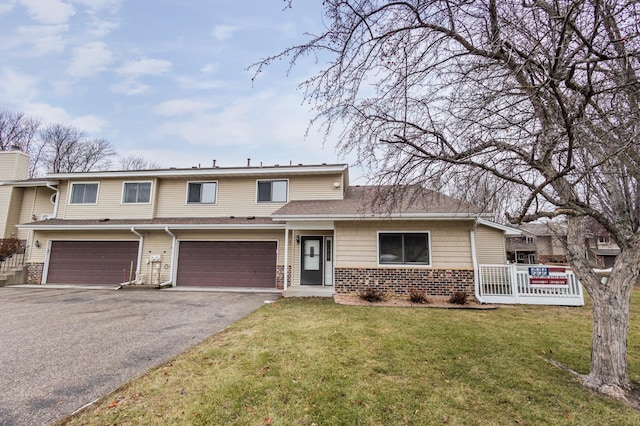 view of front of home featuring a garage and a front lawn