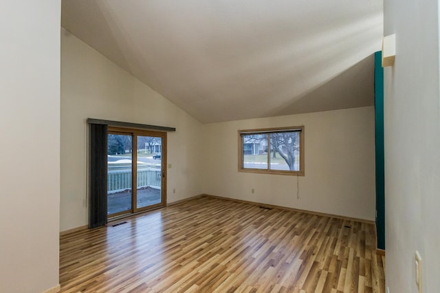 interior space with light hardwood / wood-style flooring and vaulted ceiling