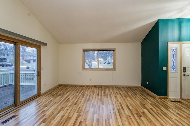 unfurnished living room with light hardwood / wood-style floors and vaulted ceiling