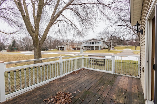 wooden terrace with a lawn