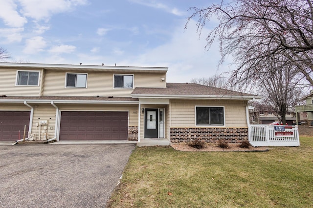 view of front of property with a front yard and a garage