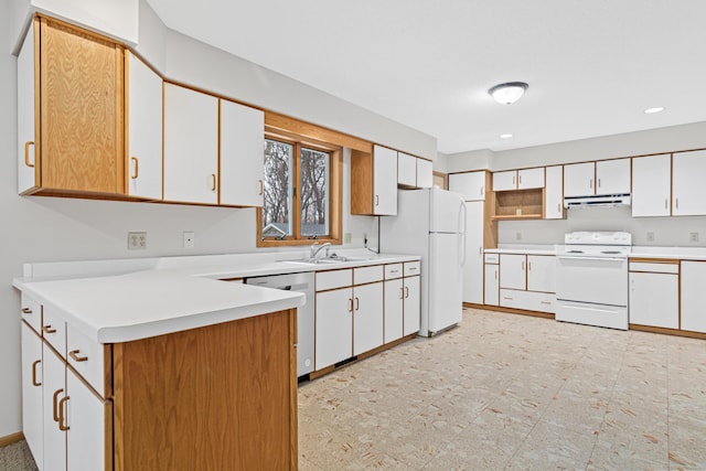 kitchen with white cabinetry, sink, and white appliances