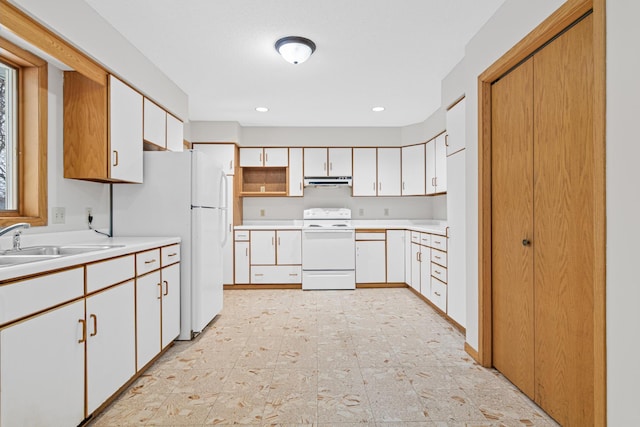 kitchen with white cabinets, white appliances, and sink