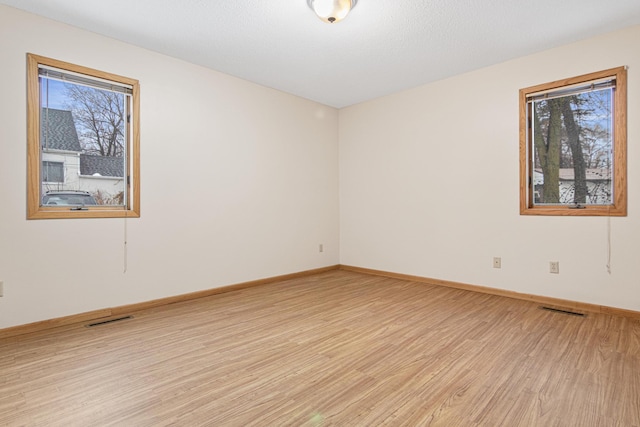 unfurnished room with light hardwood / wood-style flooring