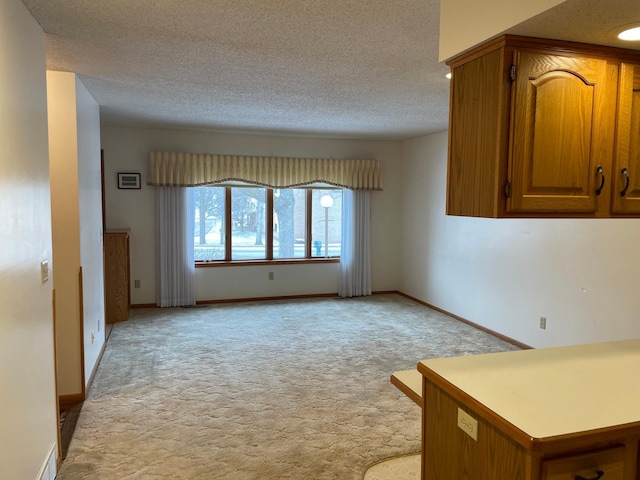 carpeted spare room with a textured ceiling