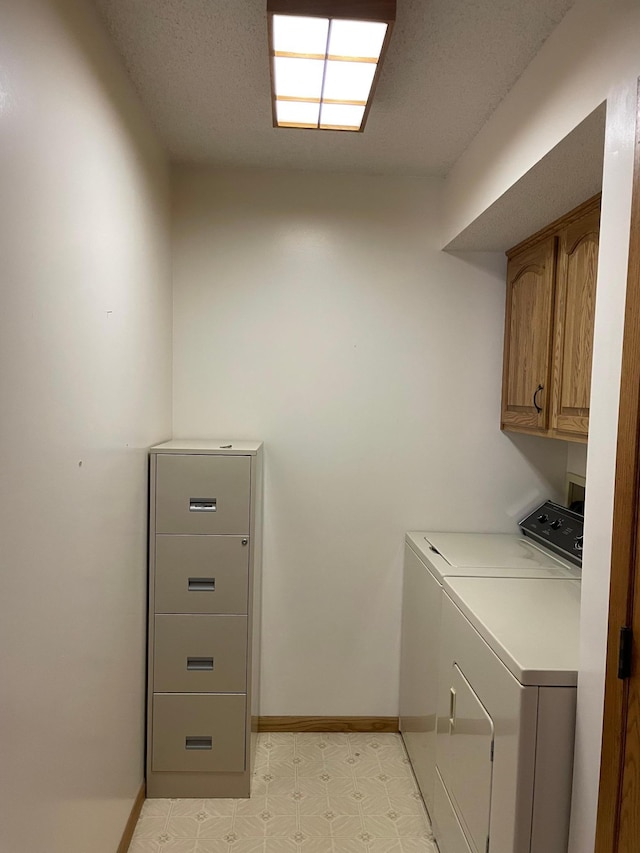 washroom featuring cabinets and independent washer and dryer