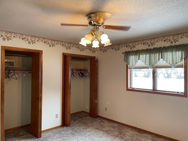 unfurnished bedroom with carpet flooring, a textured ceiling, and ceiling fan