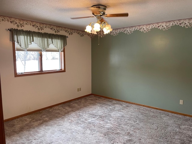 spare room featuring carpet flooring, a textured ceiling, and ceiling fan