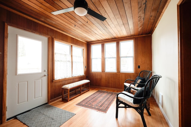 sunroom with ceiling fan and wood ceiling