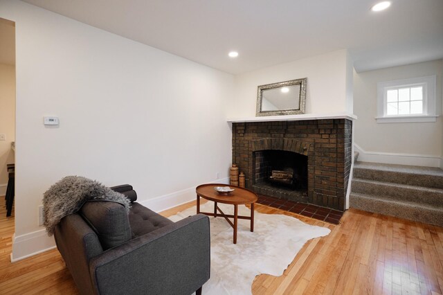 living room featuring a fireplace and wood-type flooring