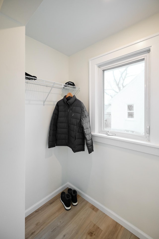 walk in closet with light wood-type flooring